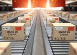 Made in China. Cardboard boxes with text made in China and chinese flag on the roller conveyor.