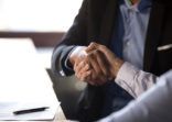 Close up african businessman shaking hands with client