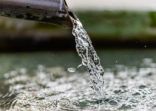 Purification water fountain in Kyoto, Japan with liquid running from spout faucet closeup