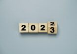 Wooden block cube flipping between 2022 to 2023 for change and preparation merry Christmas and happy new year.