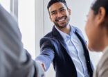 Shot of two business people shaking hands during a meeting